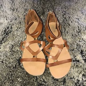 Brown sandals with gold accents